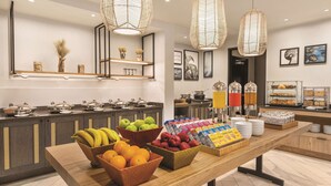 A breakfast buffet with various fruits, pastries, and beverages. - DoubleTree by Hilton Tampa Rocky Point Waterfront (Tampa)