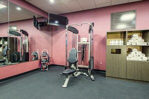 A fitness center with exercise equipment, a mirror, and a sign listing safety rules. - Best Western Plus Clemson Hotel & Conference Center (Clemson)