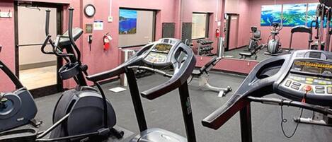 A gym with treadmills, stationary bikes, and weight machines.