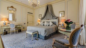 A classic hotel room with a large bed, a desk, and a chair. - Olissippo Lapa Palace – The Leading Hotels of the World (Lisbon)