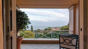 A balcony with a potted plant, a table, and a chair. - Olissippo Lapa Palace – The Leading Hotels of the World (Lisbon)