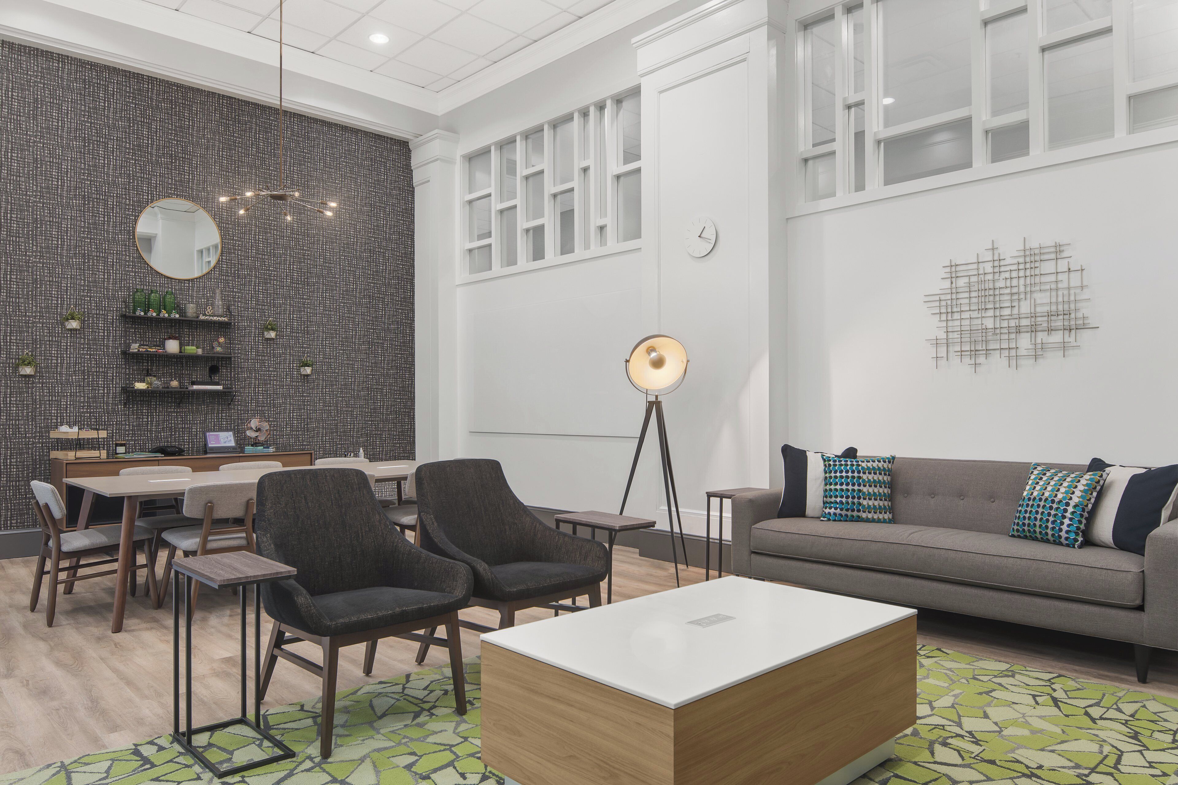 A modern interior with a dining area, seating, and a large window.