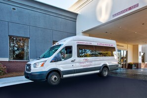 A white van parked in front of a building with a sign reading "CROWNE PLAZA" and "CLEARANCE 13'0". - Crowne Plaza Hotel Greenville-I-385-Roper Mtn Rd by IHG (Greenville)