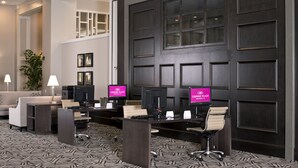 A hotel lobby with a reception desk, computers, and a seating area. - Crowne Plaza Hotel Greenville-I-385-Roper Mtn Rd by IHG (Greenville)