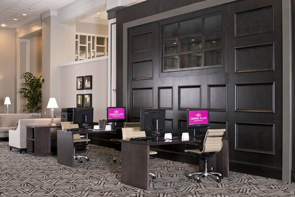 A hotel lobby with a reception desk, computers, and a seating area. - Crowne Plaza Hotel Greenville-I-385-Roper Mtn Rd by IHG (Greenville)