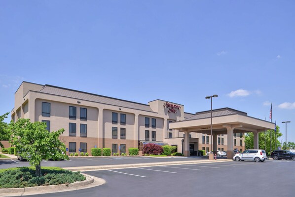 Hotel features a modern design with a flat roof and symmetrical facade, offering a covered entrance and multiple rooms.