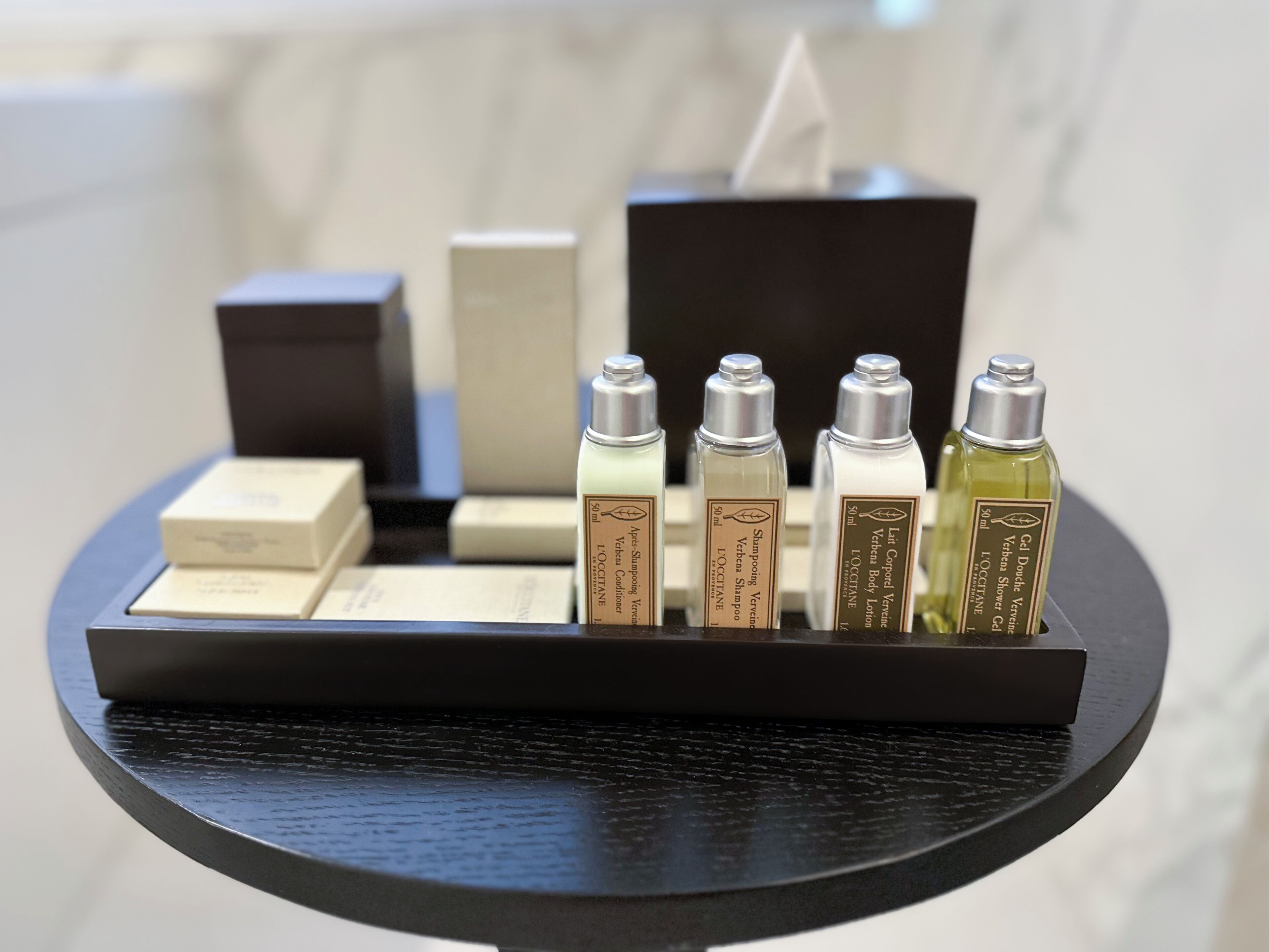A display of toiletries on a black tray.