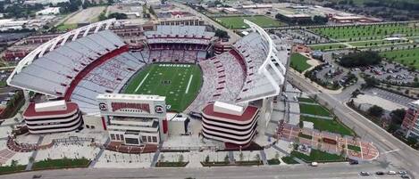 A large stadium with a football field, multiple seating tiers, and a prominent entrance.