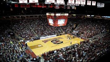 A basketball court with spectators in a large indoor arena.