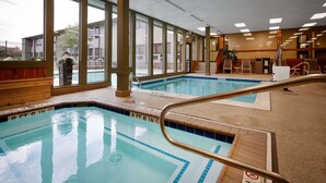 An indoor swimming pool with clear markings and a view of the outside.