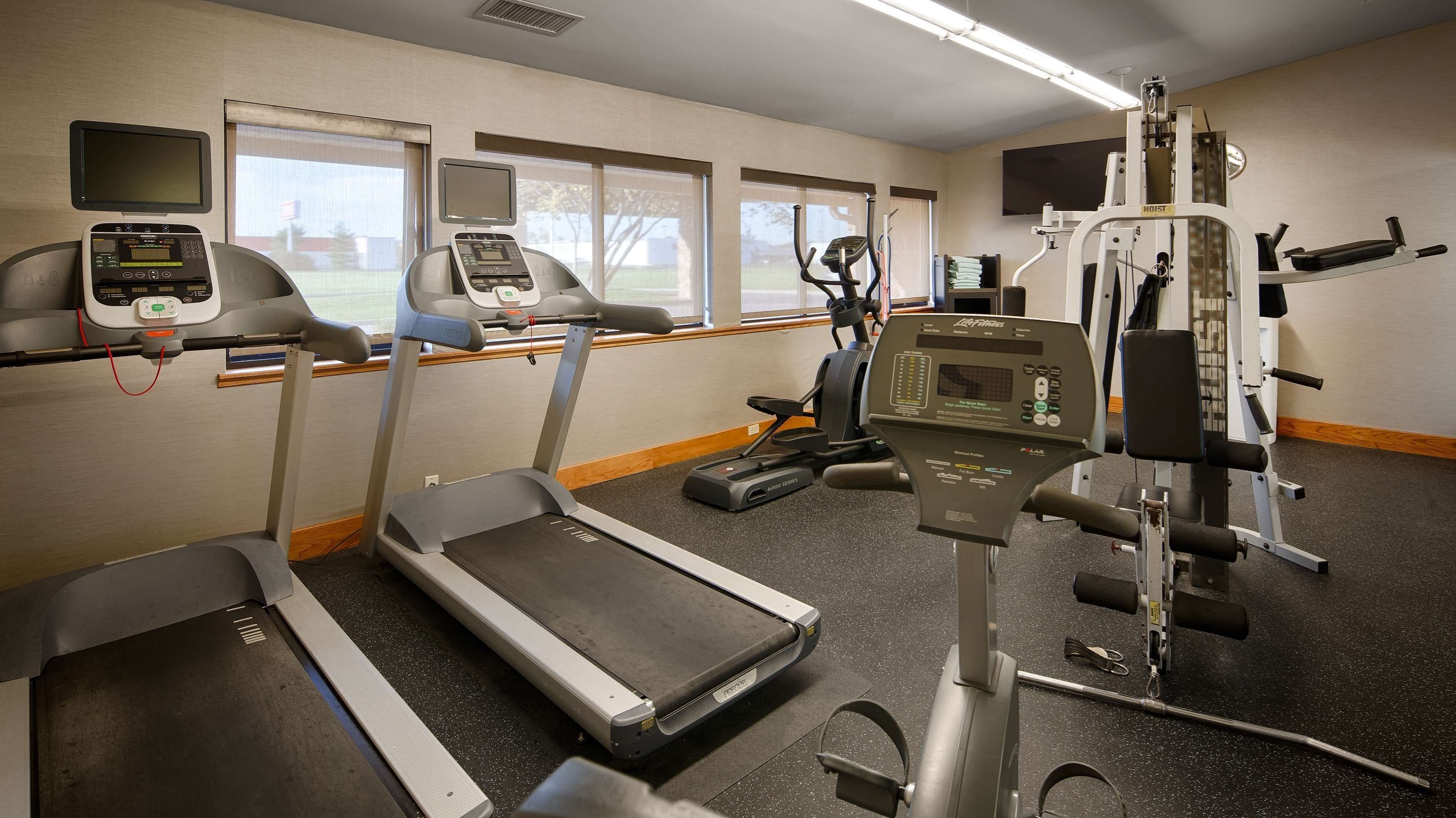 A gym with treadmills, an elliptical, and a weight machine.