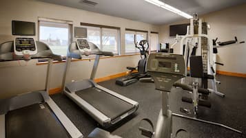 A gym with treadmills, an elliptical, and a weight machine.