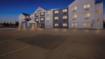 A multi-story hotel with a modern design, featuring a prominent 'Spark' sign at the entrance.