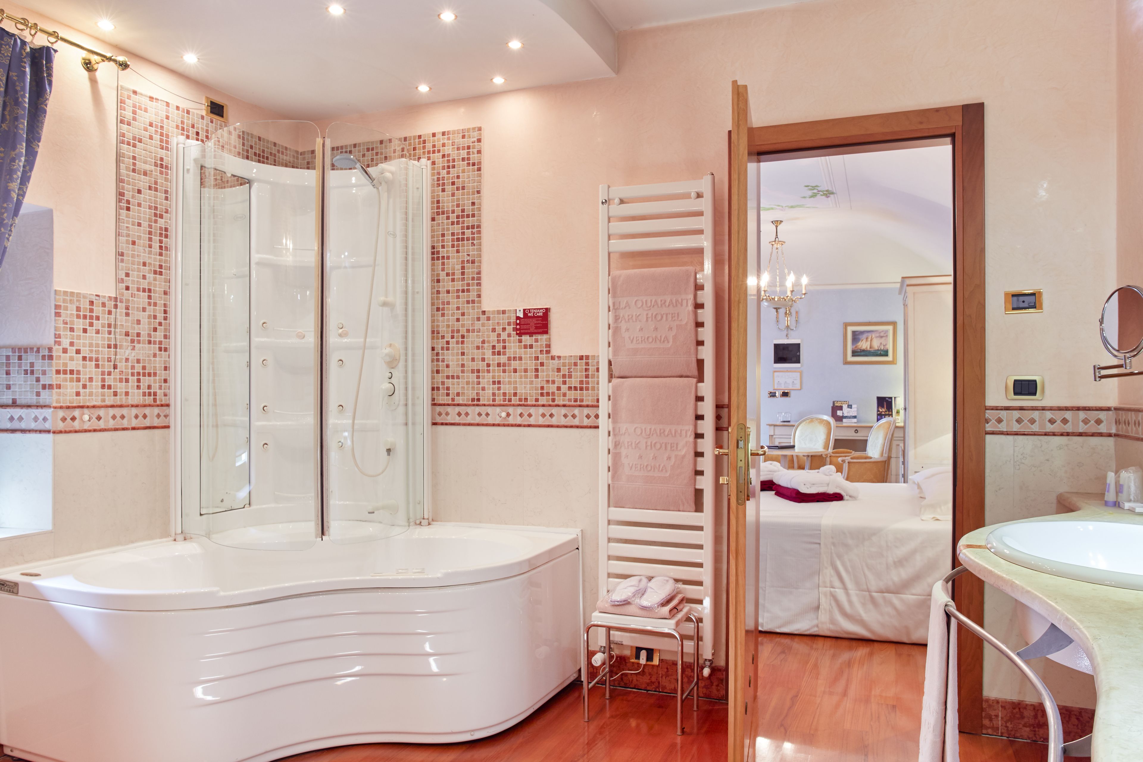 A modern bathroom with a freestanding bathtub, a glass-enclosed shower, and a vanity with a sink.