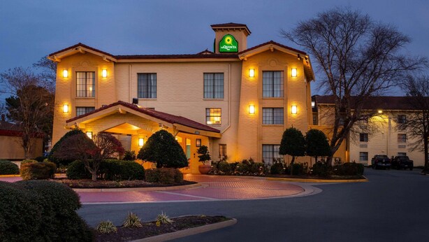 A hotel with a prominent sign, a covered entrance, and landscaped gardens. - La Quinta Inn by Wyndham Norfolk Virginia Beach (Virginia Beach)