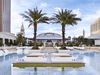 A luxurious lounge with red seating, a central bar area, and decorative crystal structures. at The Venetian Resort Las Vegas