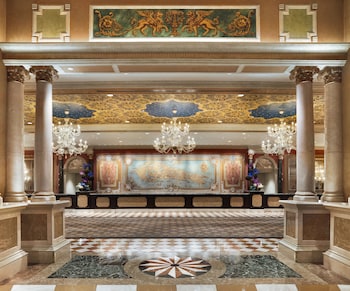 A spa area with a hot tub, tiled walls, and three wooden benches. at The Venetian Resort Las Vegas