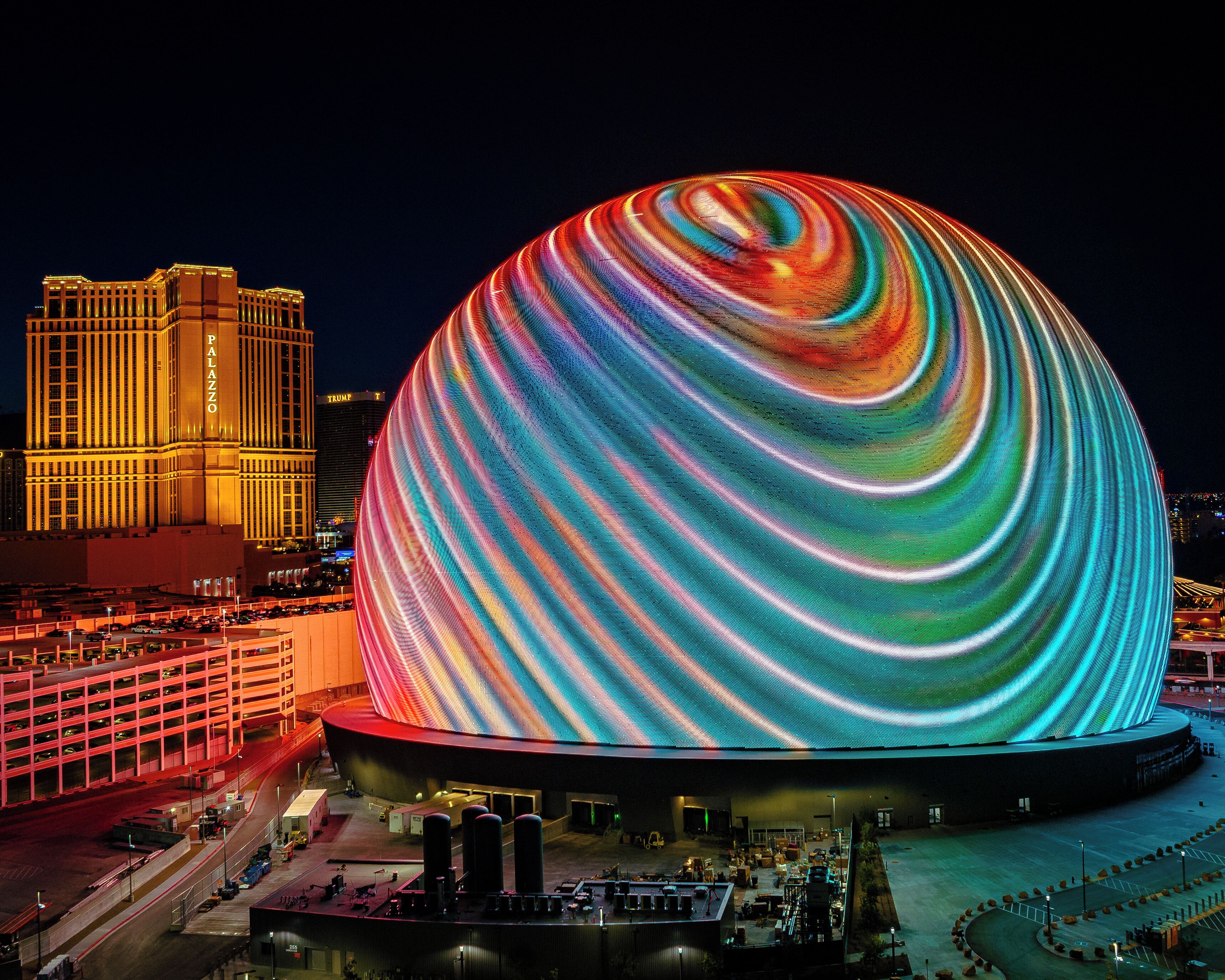 A large, illuminated dome structure with a vibrant, swirling light display.