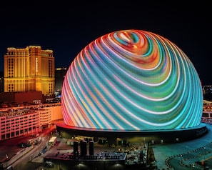 A large, illuminated dome structure with a vibrant, swirling light display.
