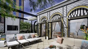 A modern outdoor lounge area with seating and a fire pit.