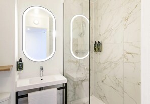 Bathtub, eco-friendly toiletries, hair dryer, towels