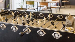 A foosball table with 'STELLA CHAMPION' branding, set in a room with chairs and a table in the background. - B&B Hotel Toulouse Université (Toulouse)