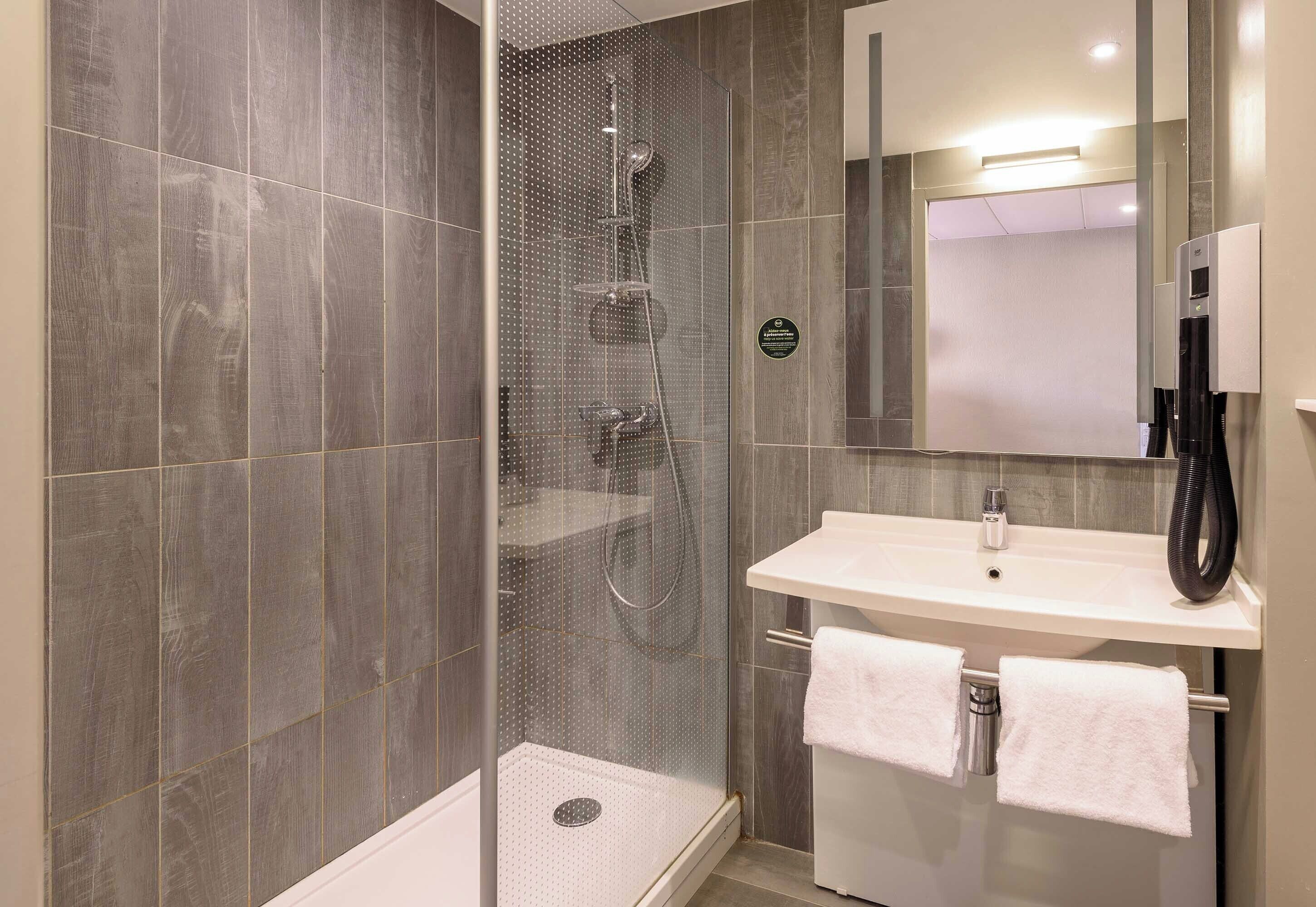 bathtub, eco-friendly toiletries, hair dryer, towels