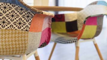 Two chairs with patchwork upholstery.