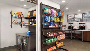 A treat shop open 24 hours with shelves stocked with snacks and beverages.