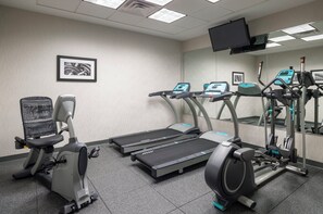 A fitness room with treadmills, an elliptical, and a stationary bike. - Holiday Inn Norwich by IHG (Norwich)
