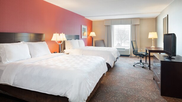 A hotel room with two beds, a desk, a chair, and a television. - Holiday Inn Norwich by IHG (Norwich)