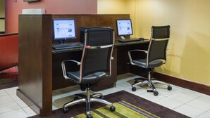 A hotel reception area with two computer workstations, each with a monitor, keyboard, and chair. - Holiday Inn Norwich by IHG (Norwich)