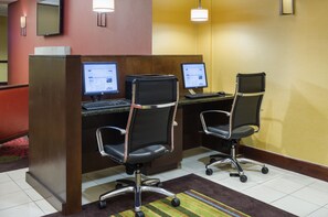 A hotel reception area with two computer workstations, each with a monitor, keyboard, and chair. - Holiday Inn Norwich by IHG (Norwich)