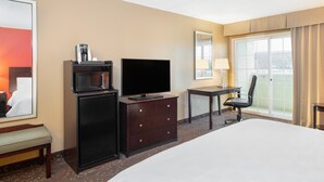 A hotel room with a bed, a desk with a chair, a television, a coffee machine, and a large window with a view. - Holiday Inn Norwich by IHG (Norwich)