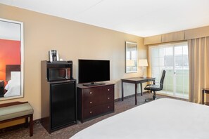 A hotel room with a bed, a desk with a chair, a television, a coffee machine, and a large window with a view. - Holiday Inn Norwich by IHG (Norwich)