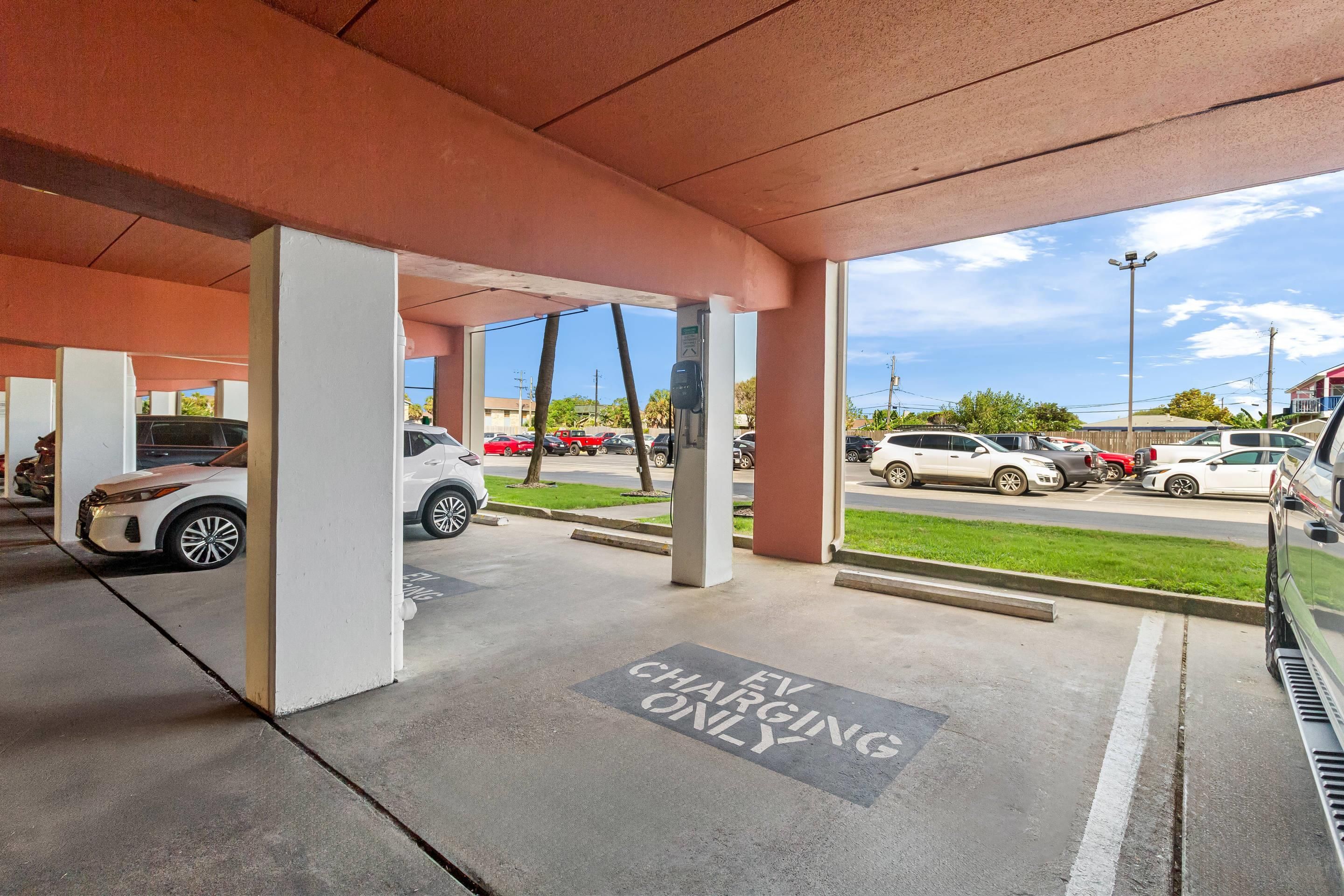 An EV charging station area with a clear view of the parking lot and street outside.
