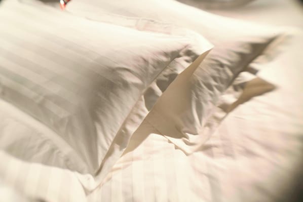 A close-up of a bed with white linens and a neatly folded blanket. - San Diego Marriott Gaslamp Quarter (San Diego)