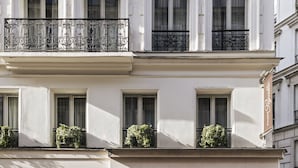 A building with a brown awning, a staircase leading to the entrance, and a sign that reads "MAISON PIGALLE". - Hôtel Maison Pigalle (Paris)