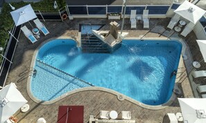 Seasonal outdoor pool, open 9:00 AM to 6:30 PM, pool umbrellas