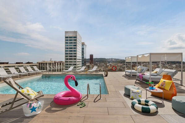 Seasonal outdoor pool, open 11:00 AM to 7:00 PM, pool loungers
