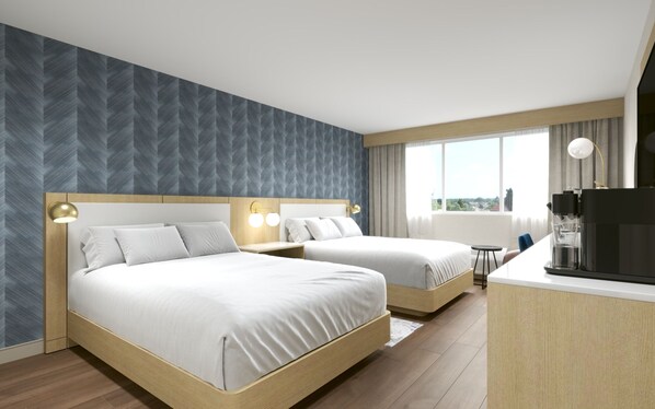 Habitación de hotel con dos camas, kitchenette y un amplio ventanal con vista a la ciudad.