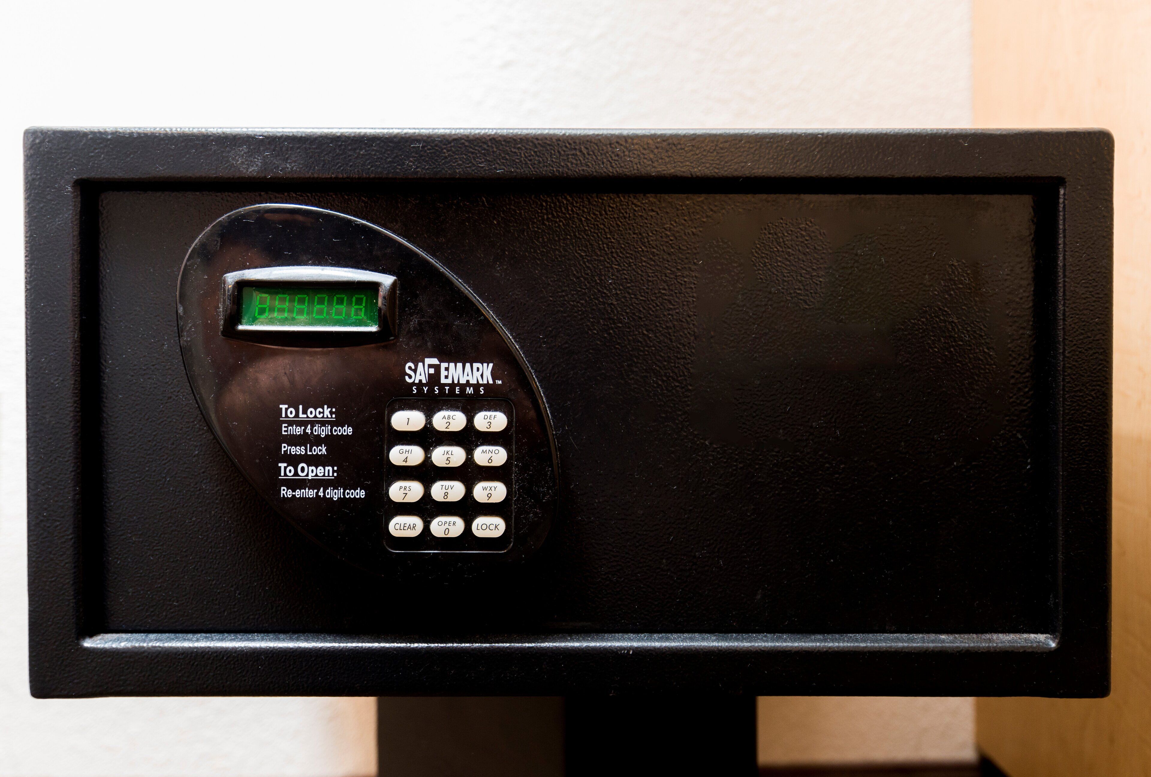 A black electronic keypad with a digital display, instructions for locking and unlocking, and a brand name 'SAFEMARK SYSTEMS'.