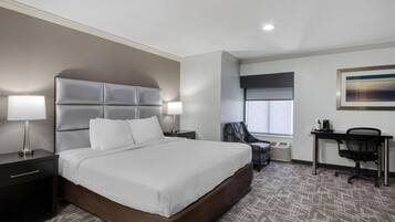 Premium bedding, desk, laptop workspace, blackout drapes