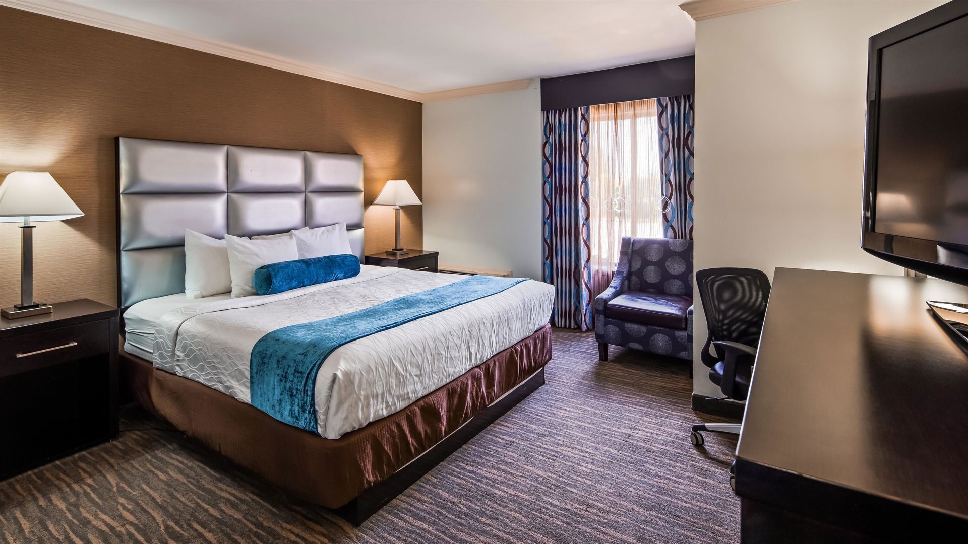 Premium bedding, desk, laptop workspace, blackout curtains