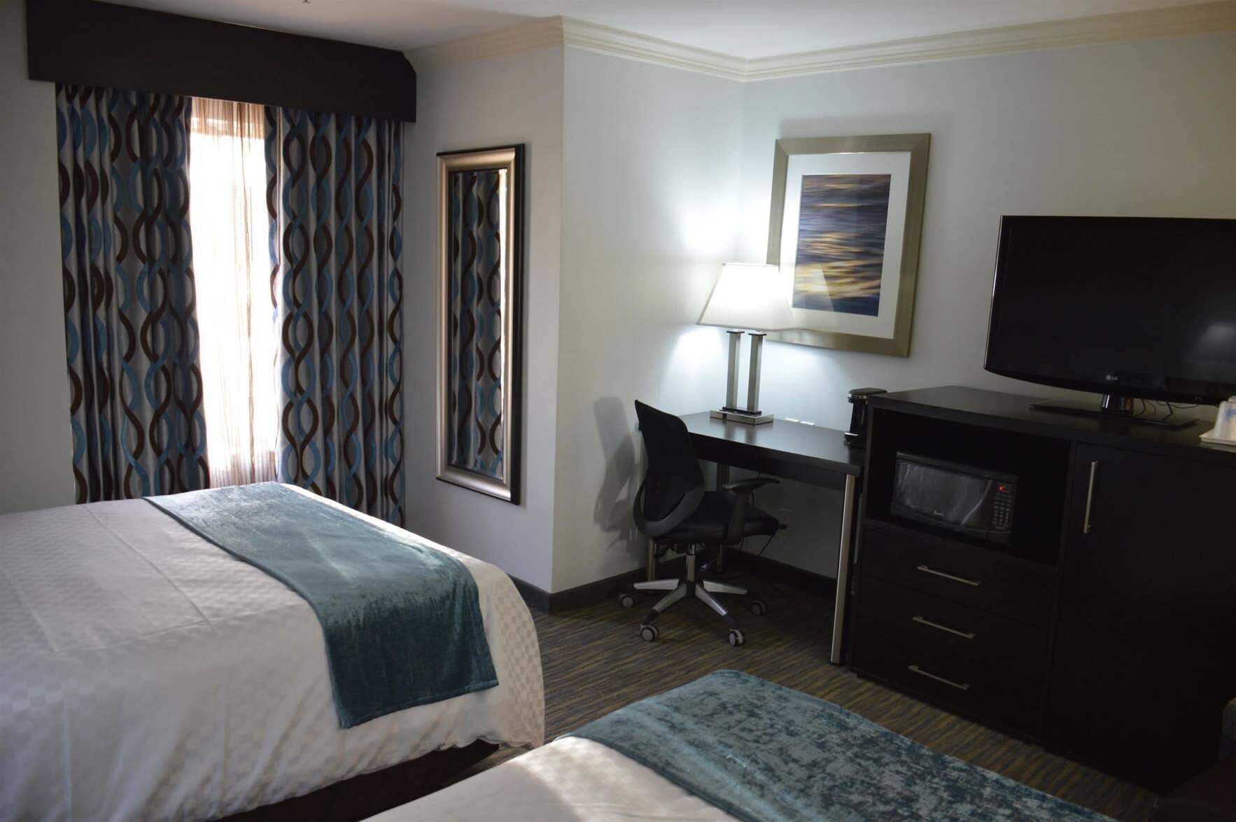 Premium bedding, desk, laptop workspace, blackout curtains