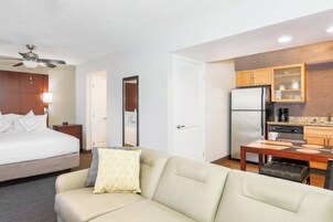 Desk, laptop workspace, iron/ironing board, bed sheets