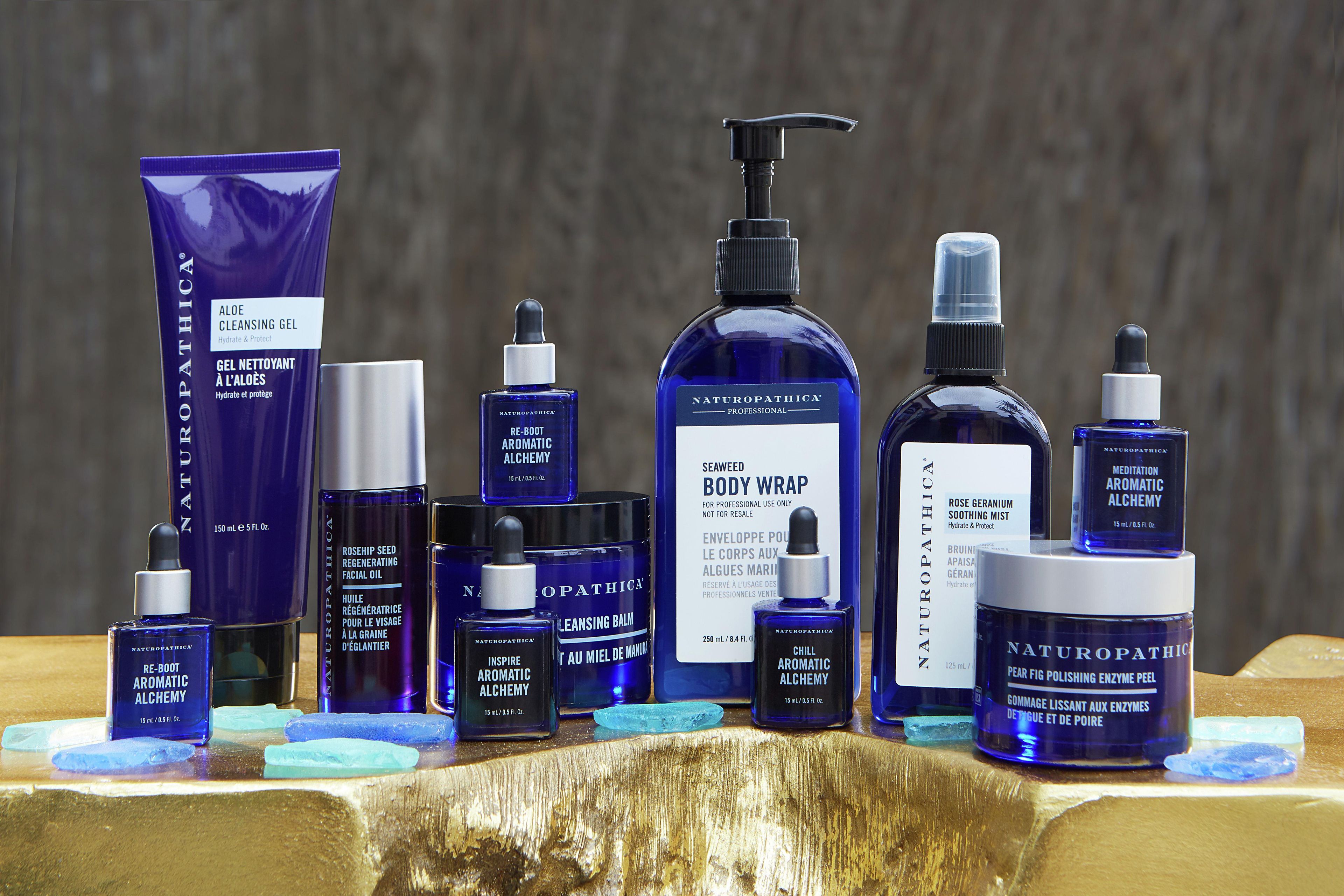 A variety of skincare products arranged on a wooden surface.