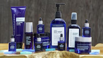 A variety of skincare products arranged on a wooden surface.