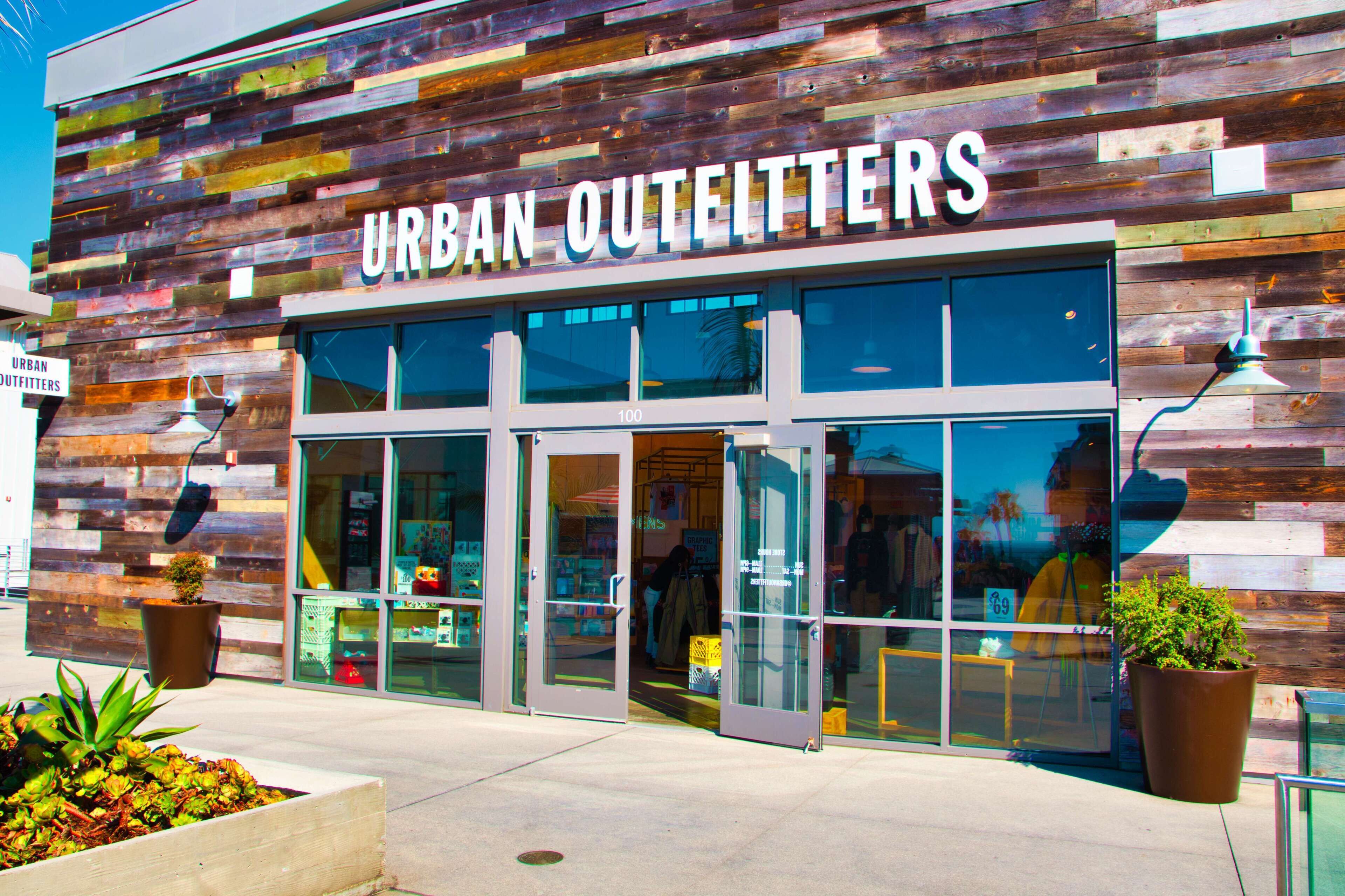 A storefront with a sign reading "URBAN OUTFITTERS" and large glass windows.