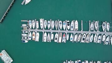 A marina with multiple boats docked at piers.